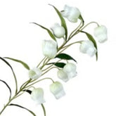 Huitich artificial flowers with white bell-shaped blooms and green leaves next to gold and green chopstick holder